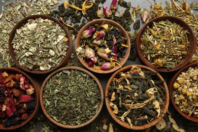 Flat lay composition with different dry teas on table