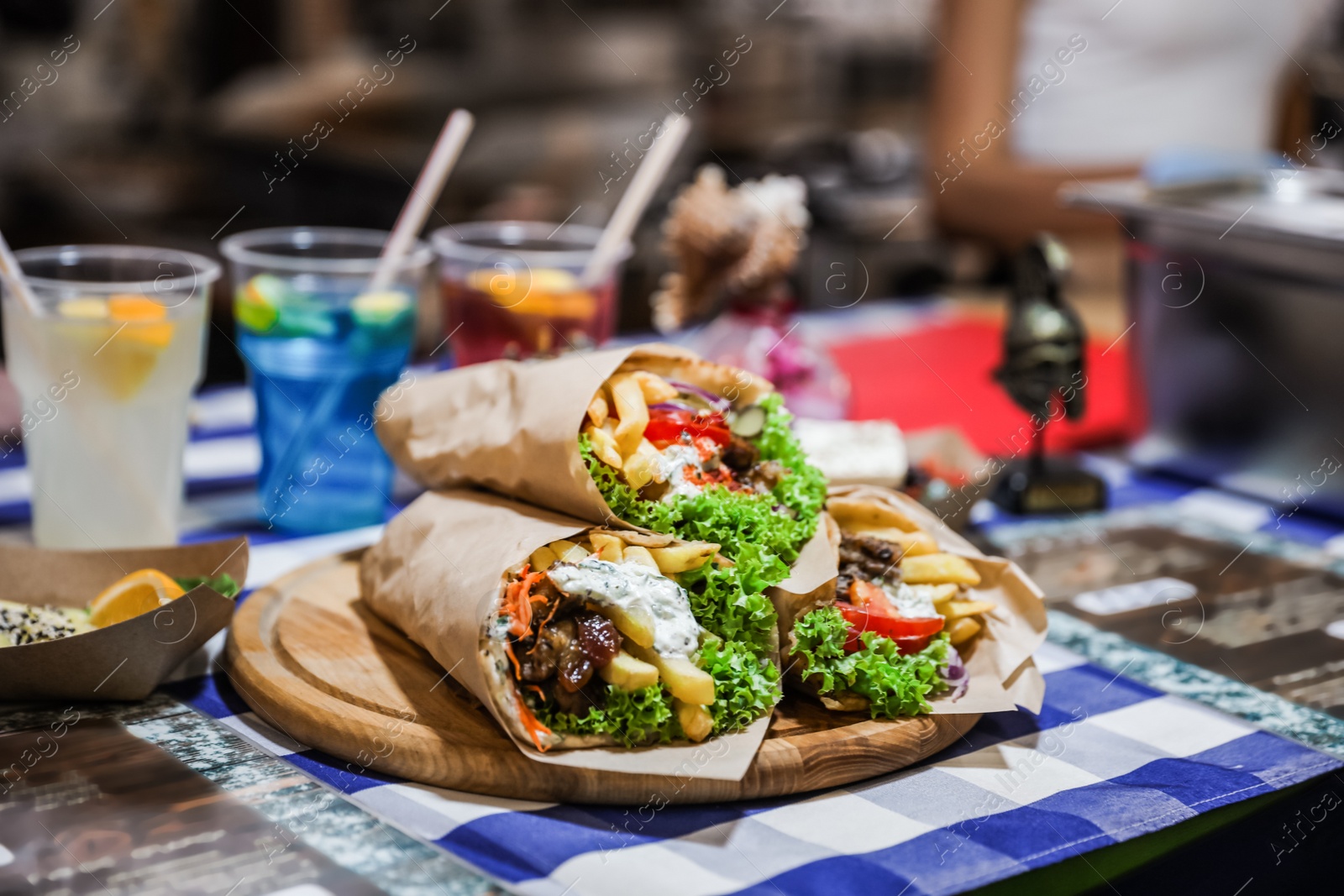 Photo of Tasty wraps with french fries on table. Fast food