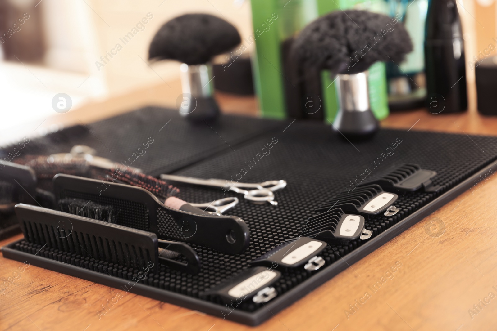 Photo of Stylish hairdresser's workplace with professional tools in barbershop, closeup