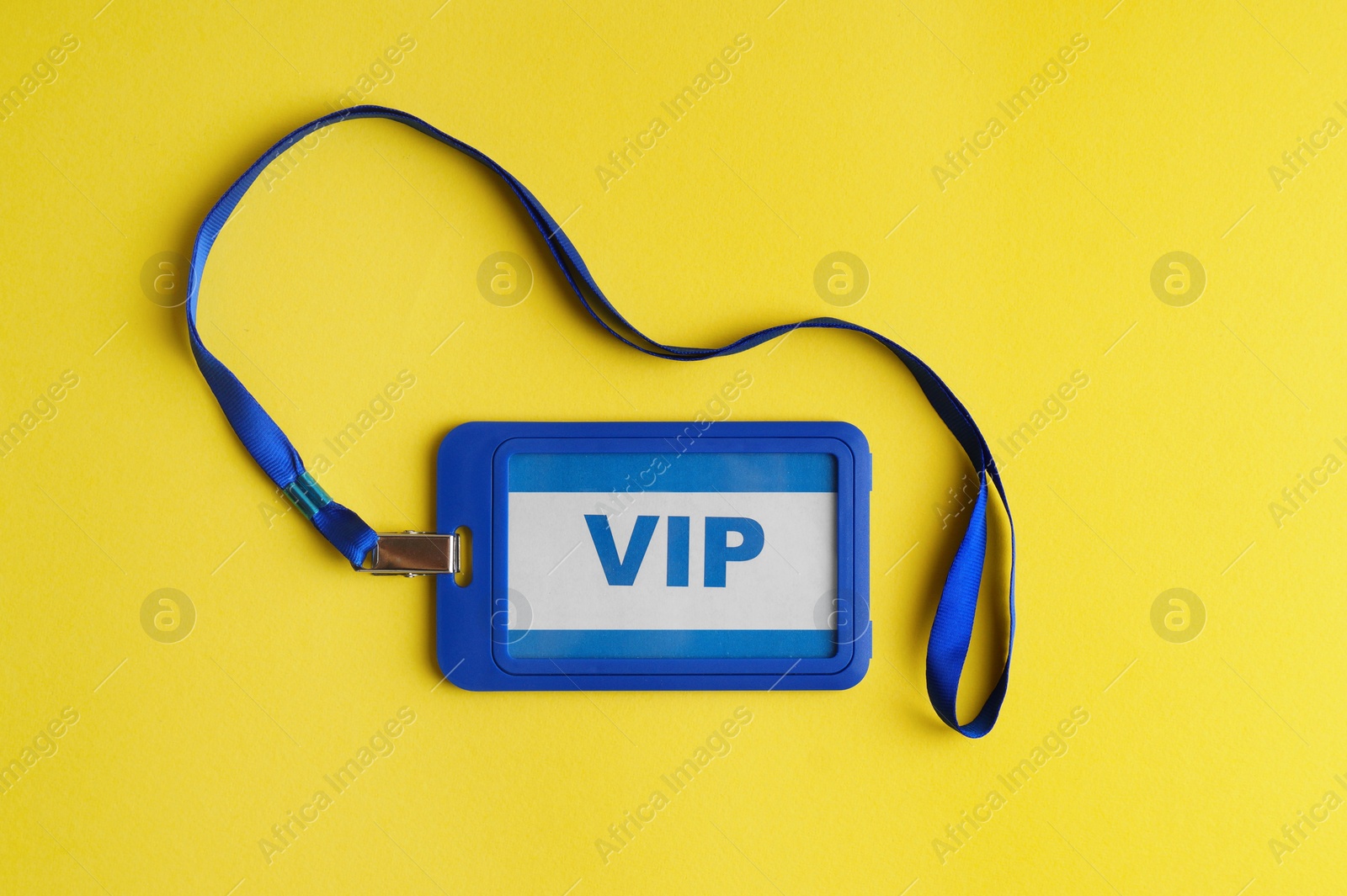 Photo of Vip badge on yellow background, top view