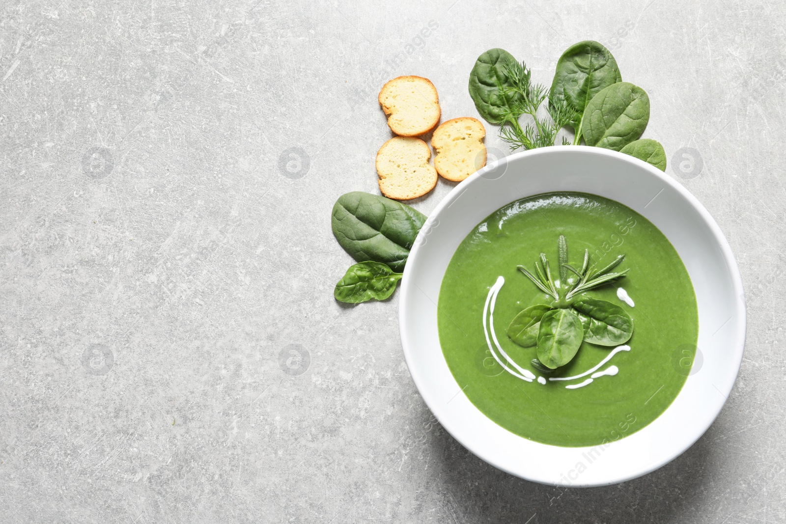 Photo of Flat lay composition with fresh vegetable detox soup made of spinach and space for text on table