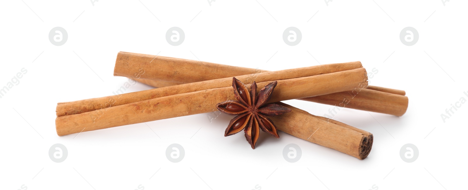 Photo of Aromatic cinnamon sticks and anise isolated on white