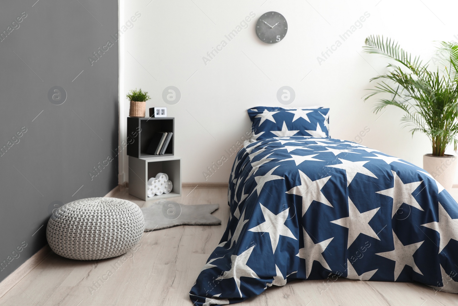 Photo of Bed with stylish linens in children's room