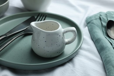 Stylish empty dishware and cutlery on table, closeup