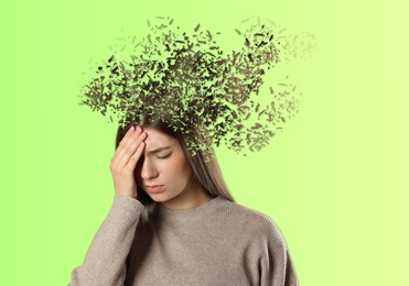 Image of Thoughtful woman with flying pieces from her head symbolizing amnesia on light green background