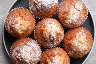 Photo of Delicious sweet muffins on light grey table, top view