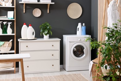 Photo of Laundry room interior with washing machine and furniture