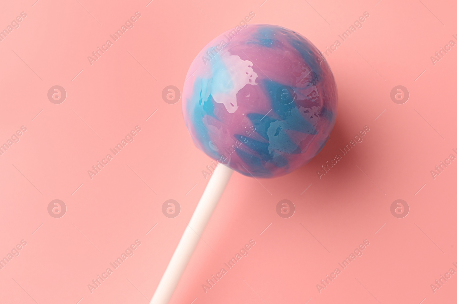 Photo of Tasty lollipop on pink background, top view