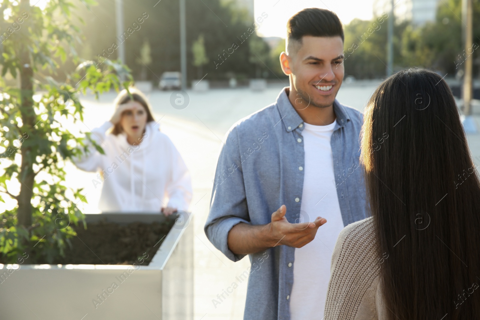 Photo of Jealous ex girlfriend spying on couple outdoors