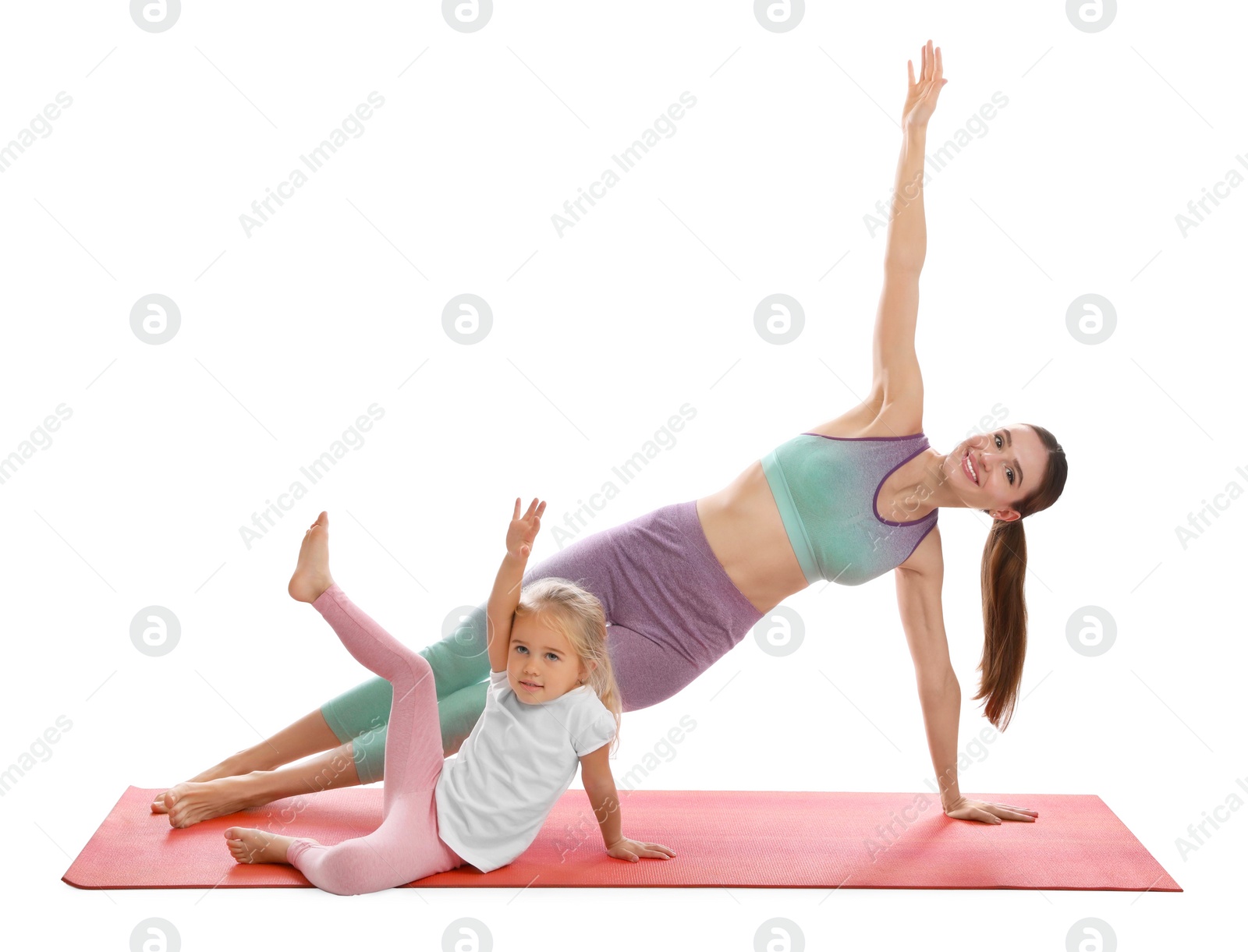 Photo of Young woman and her daughter doing exercise isolated on white. Home fitness