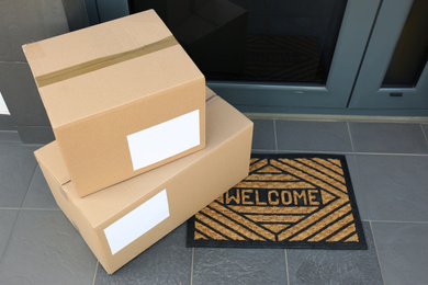 Cardboard boxes near door. Parcel delivery service