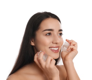 Photo of Young woman with ice cubes on white background. Skin care