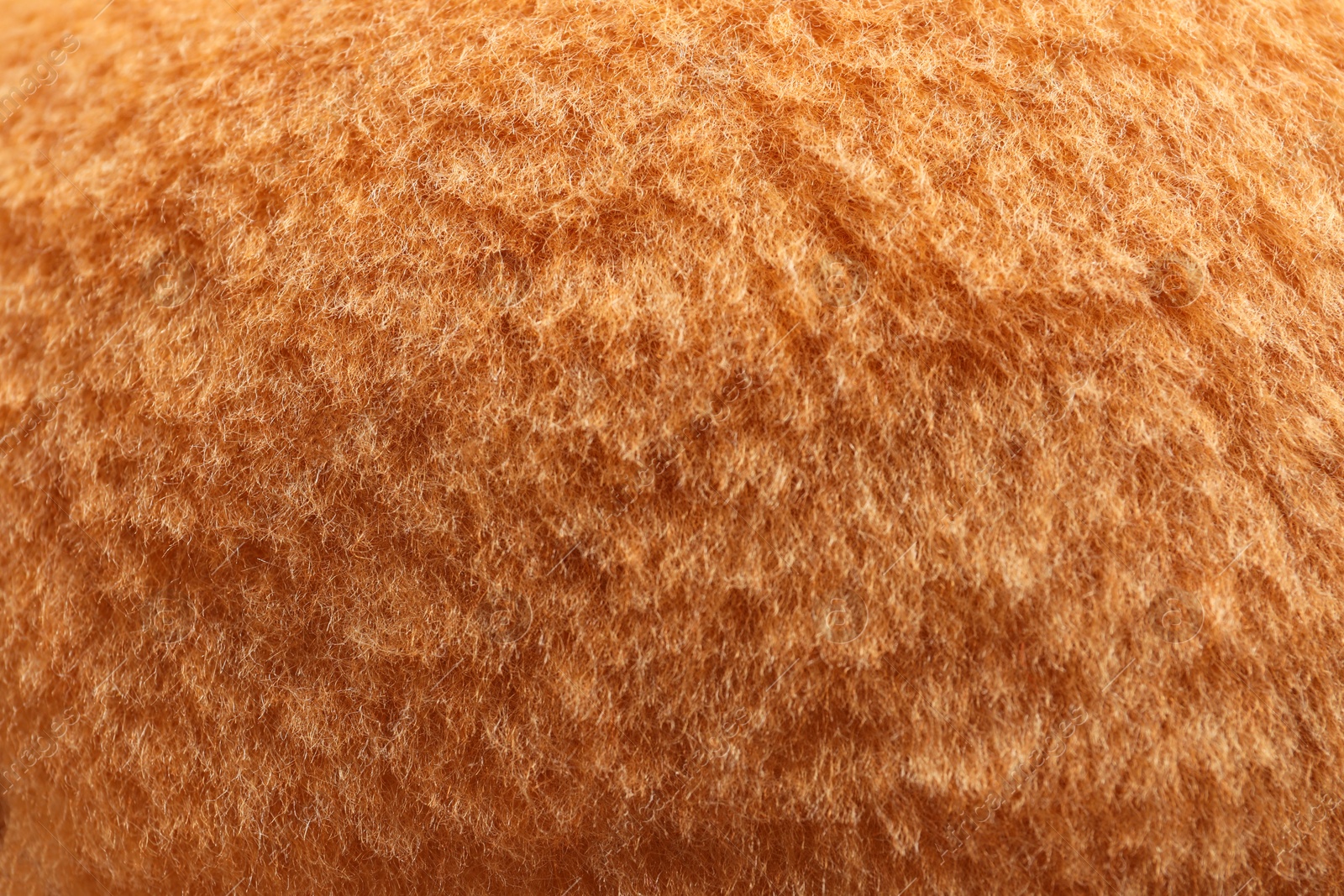 Photo of Texture of orange faux fur as background, closeup