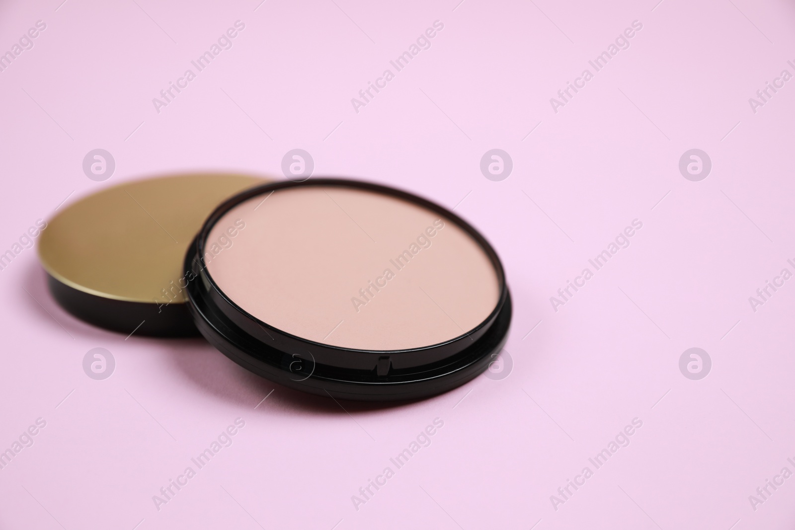 Photo of Face powder on pink background, space for text. Decorative cosmetic