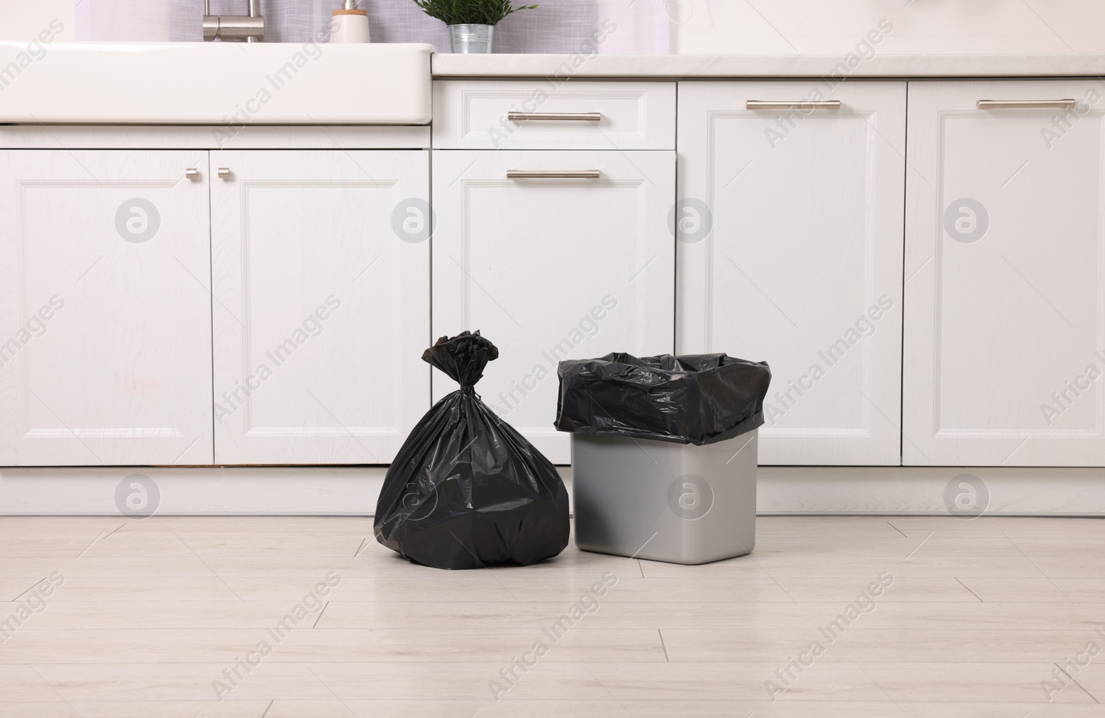 Photo of Plastic garbage bag and trash can in kitchen