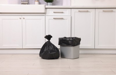 Photo of Plastic garbage bag and trash can in kitchen