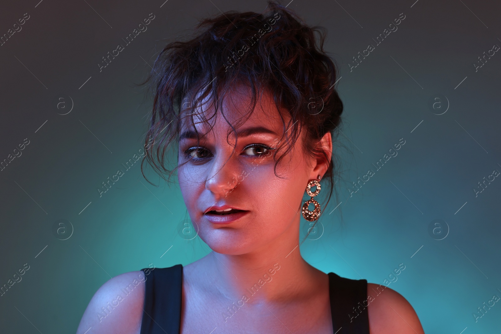 Photo of Portrait of beautiful woman on dark background with neon lights