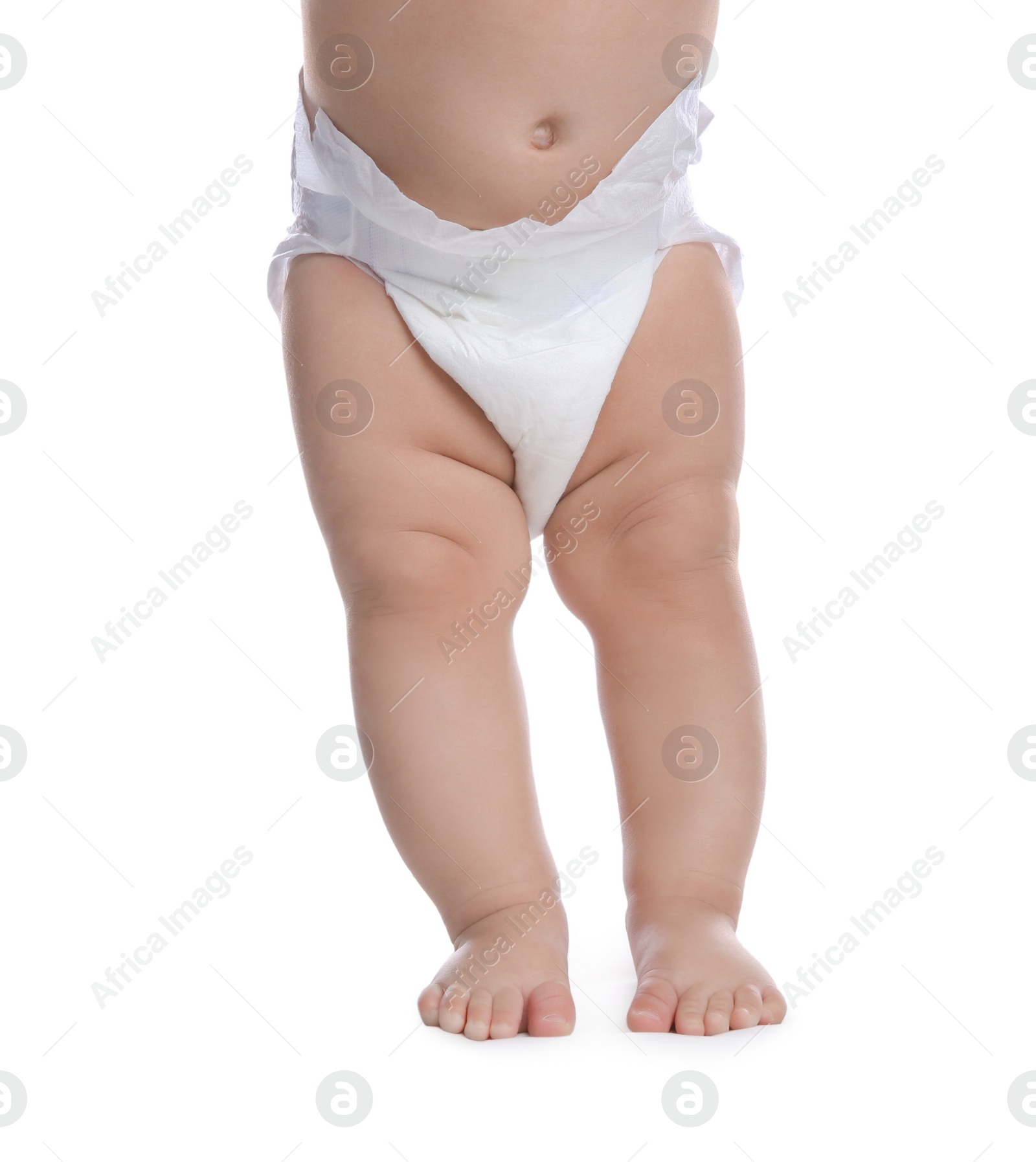 Photo of Cute baby in dry soft diaper standing on white background, closeup