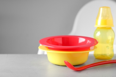 Set of plastic dishware on white table. Serving baby food