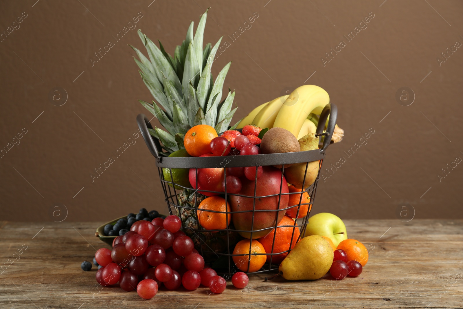 Photo of Assortment of fresh exotic fruits on wooden table