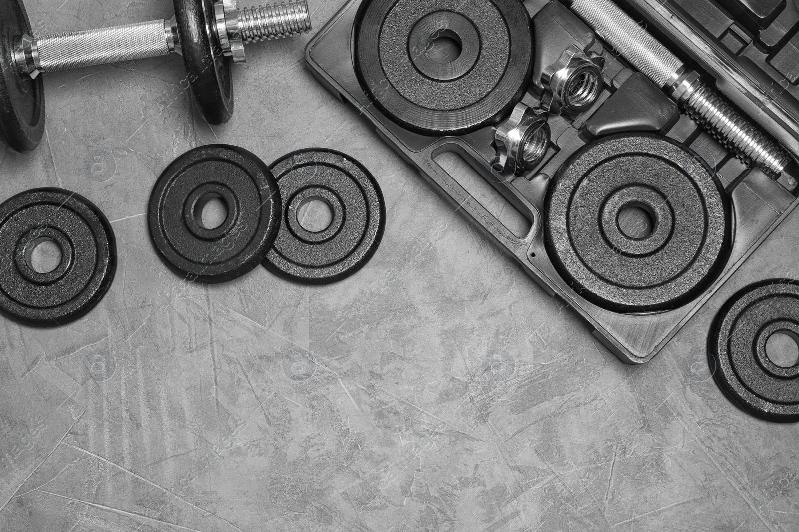 Photo of Flat lay composition with dumbbell and space for text on gray background