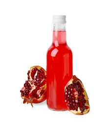 Photo of Delicious kombucha in glass bottle and pomegranate isolated on white