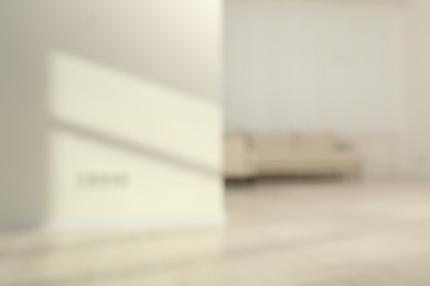 Photo of Blurred view of room with sofa and shadows on wall