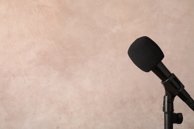 Photo of Modern microphone on color background. Space for text