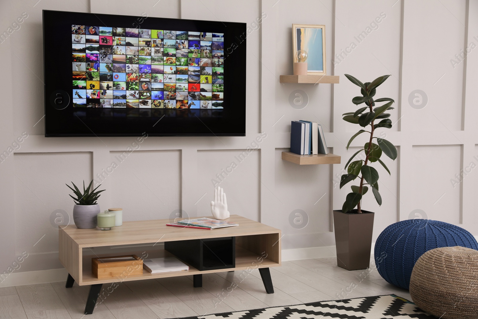 Photo of Stylish living room interior with modern TV on white wall