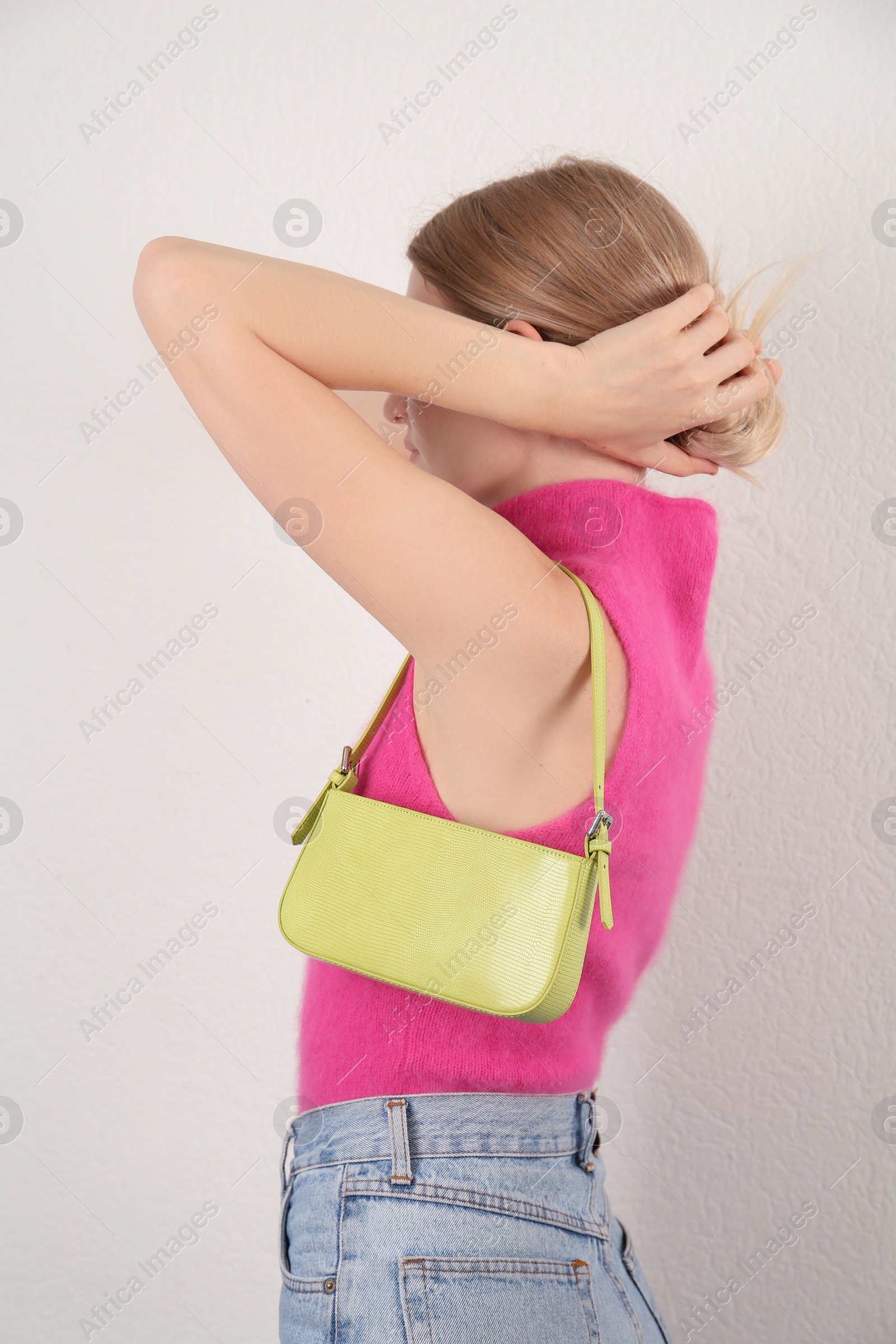 Photo of Woman with stylish baguette handbag on white background
