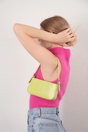 Photo of Woman with stylish baguette handbag on white background