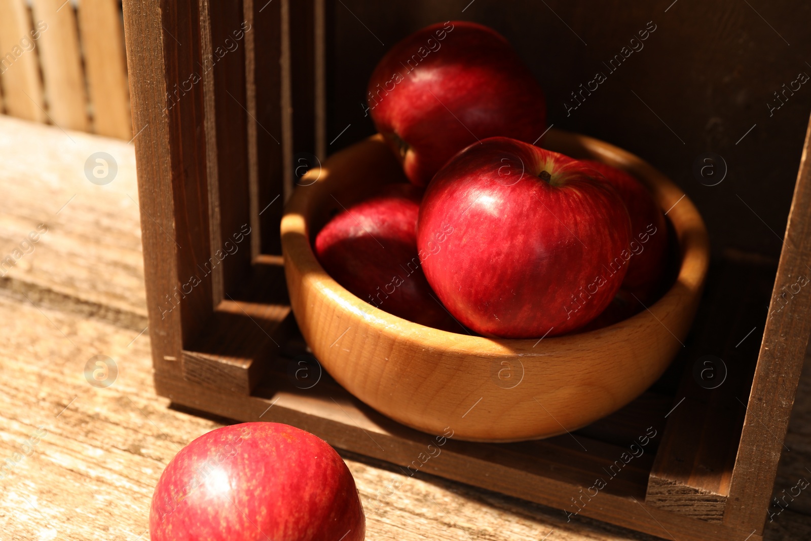 Photo of Fresh red apples on wooden table, closeup