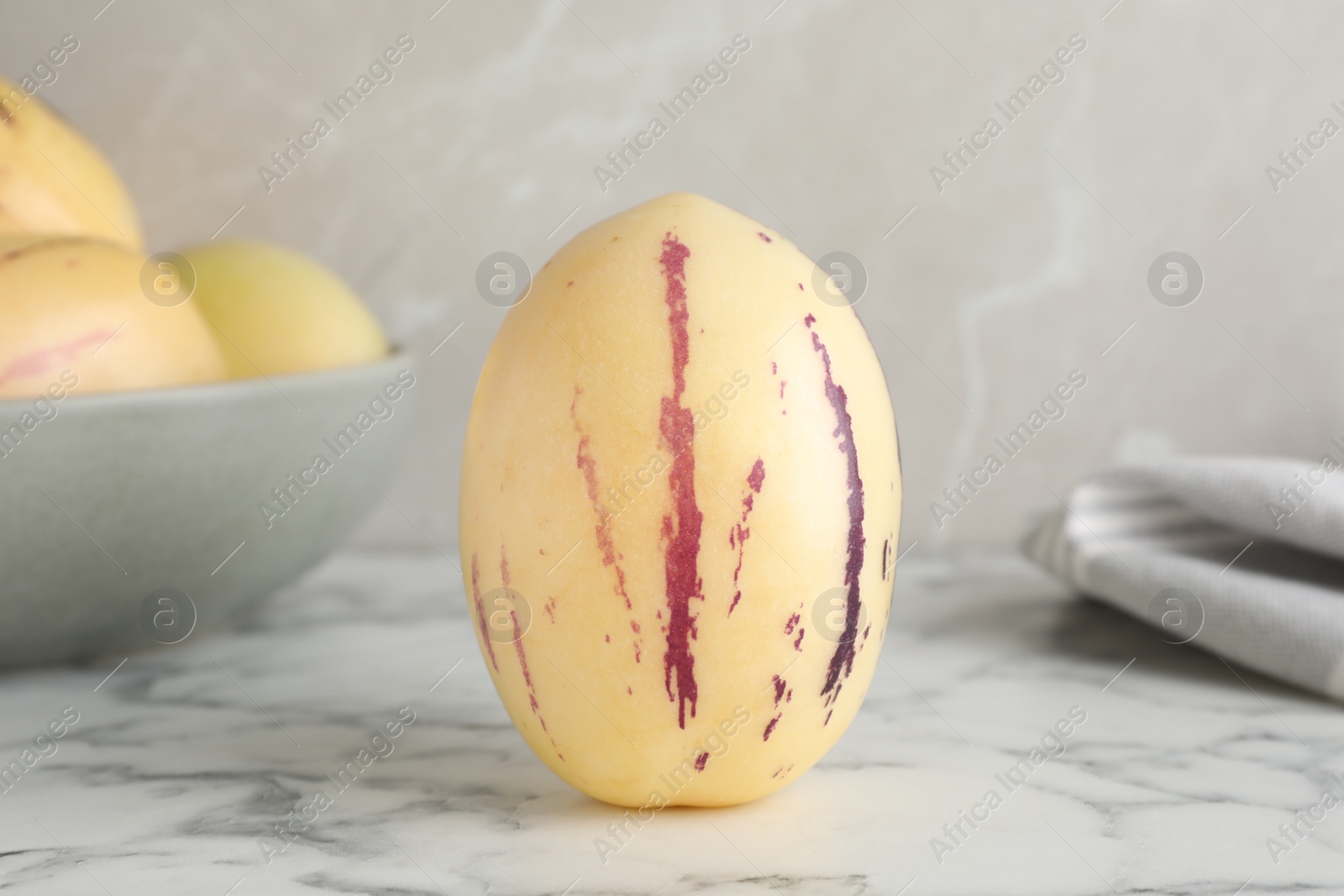 Photo of Fresh ripe pepino melon on white marble table