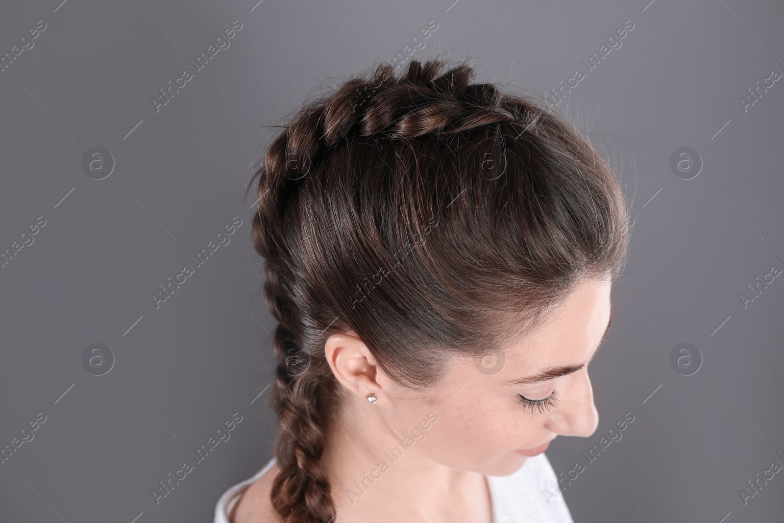 Photo of Woman with braided hair on grey background