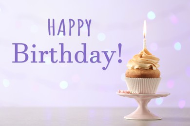 Happy Birthday! Delicious cupcake with burning candle on table