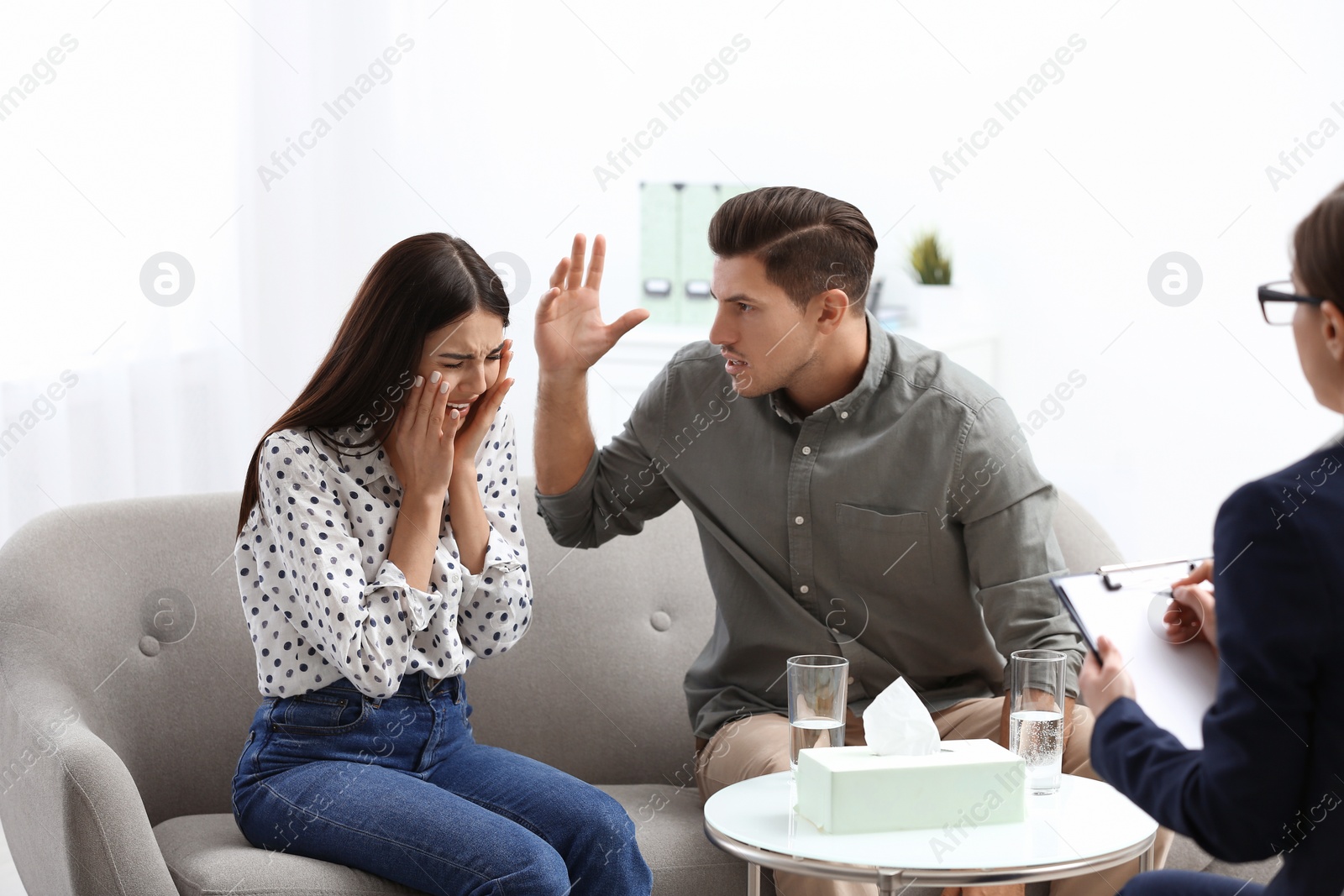 Photo of Professional psychologist working with couple in office