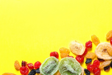 Different dried fruits on color background, top view with space for text. Healthy lifestyle