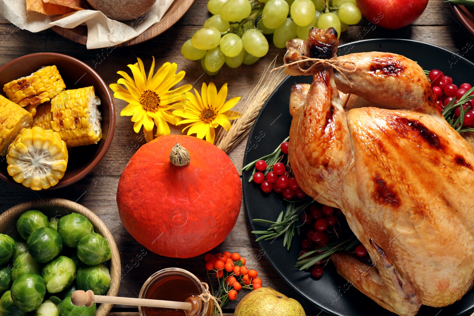 Photo of Flat lay composition with turkey on wooden background. Happy Thanksgiving day