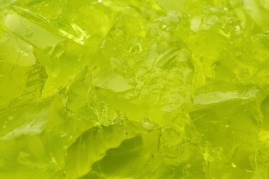 Photo of Green tasty fruit jelly as background, closeup