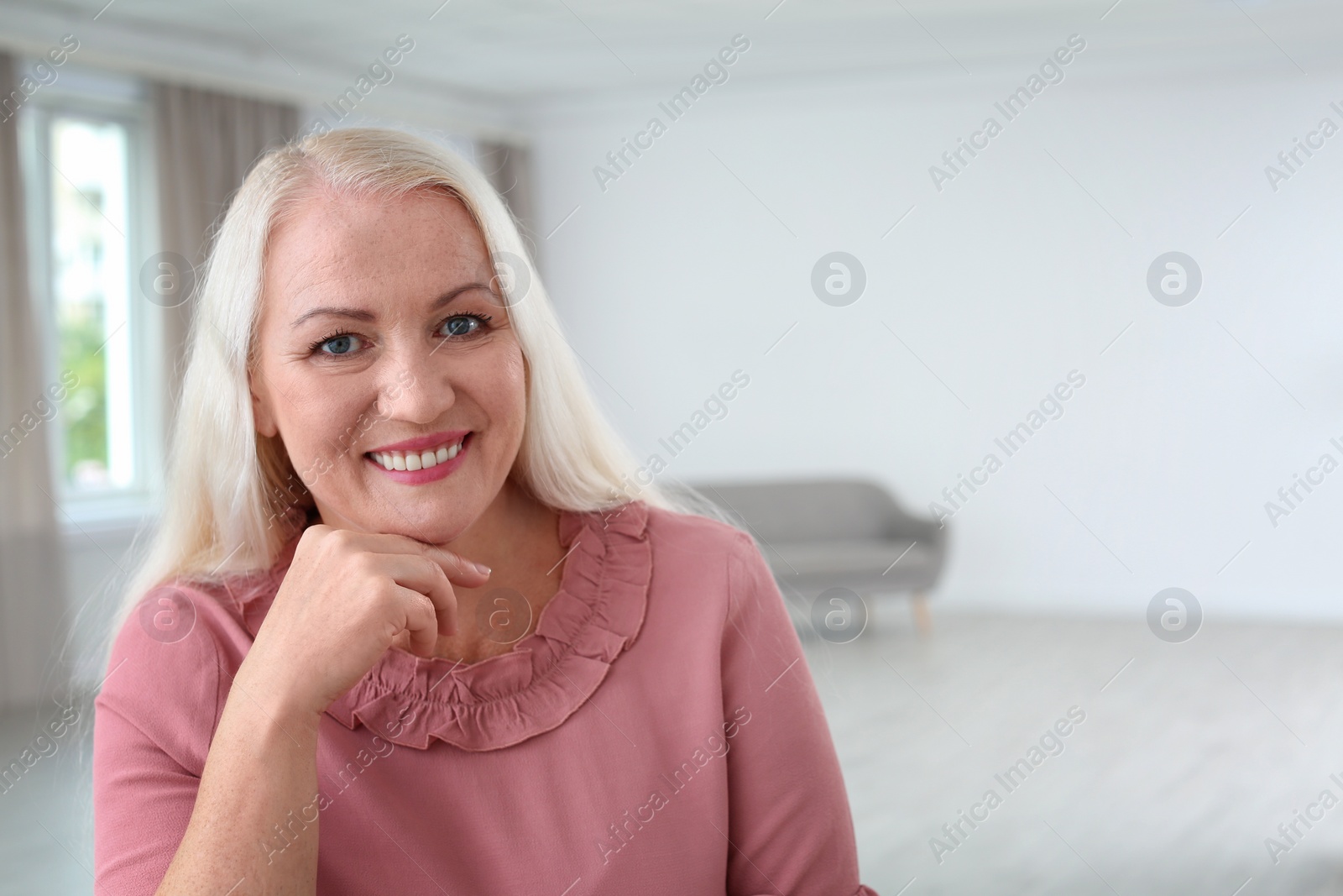 Photo of Portrait of beautiful older woman against blurred background with space for text