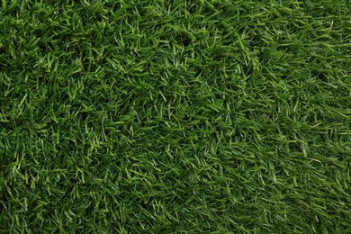 Photo of Green artificial grass as background, top view