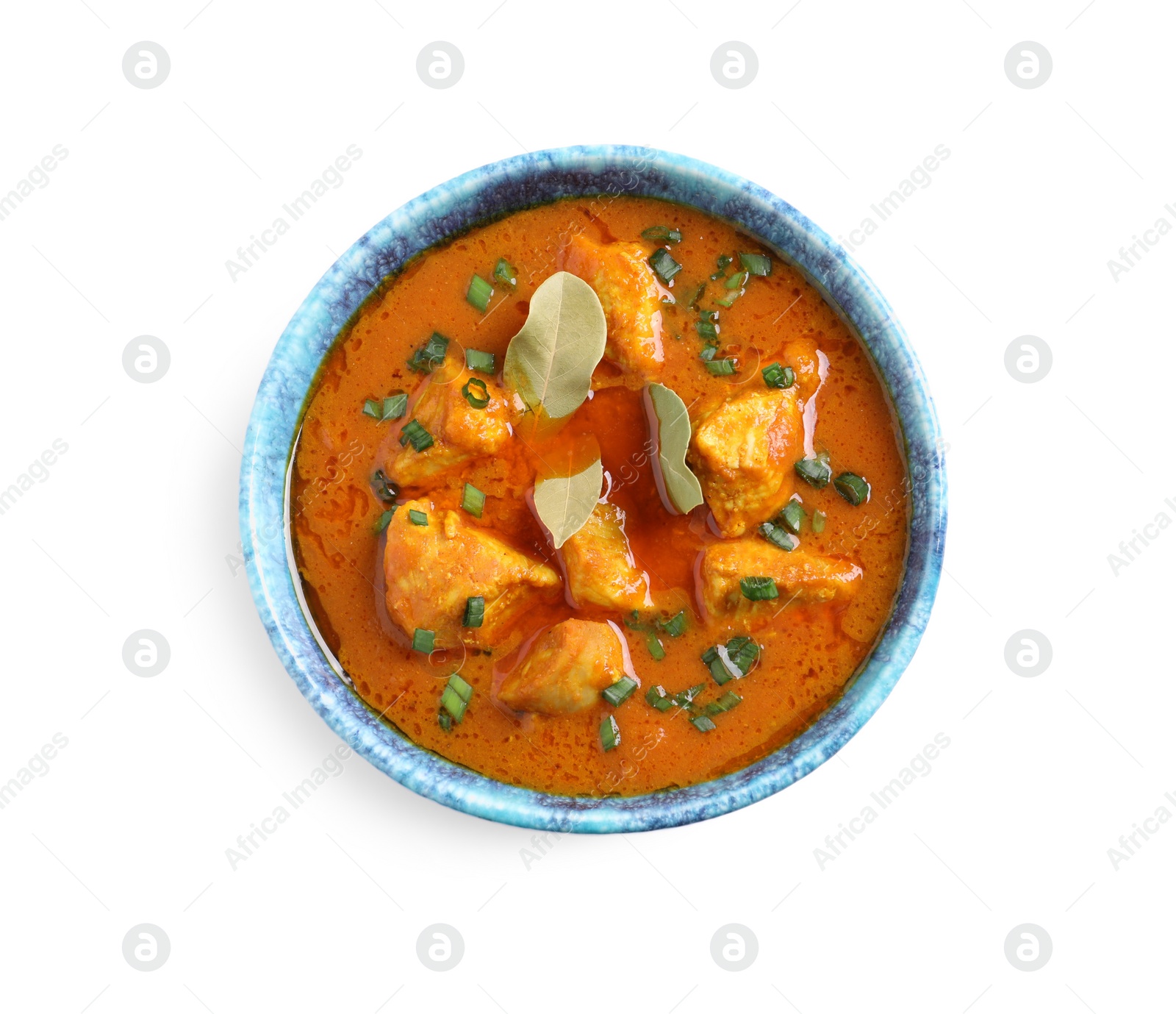 Photo of Bowl of delicious chicken curry on white background, top view