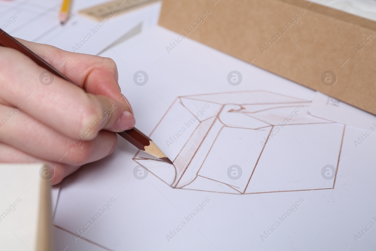 Photo of Woman creating packaging design at table, closeup