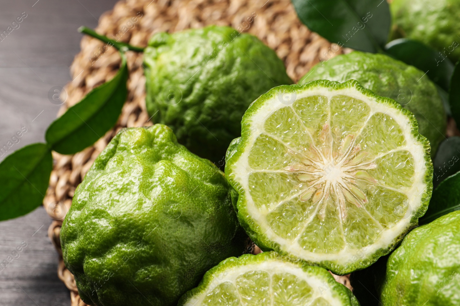 Photo of Whole and cut ripe bergamot fruits on table, closeup