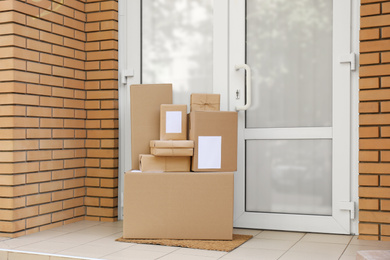 Photo of Delivered parcels on door mat near entrance