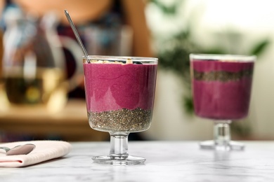 Photo of Glasses with tasty acai smoothie on table