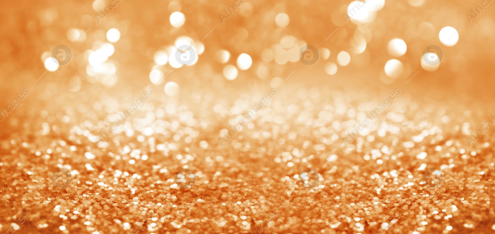 Image of Shiny orange glitter and blurred lights on background, banner design. Bokeh effect