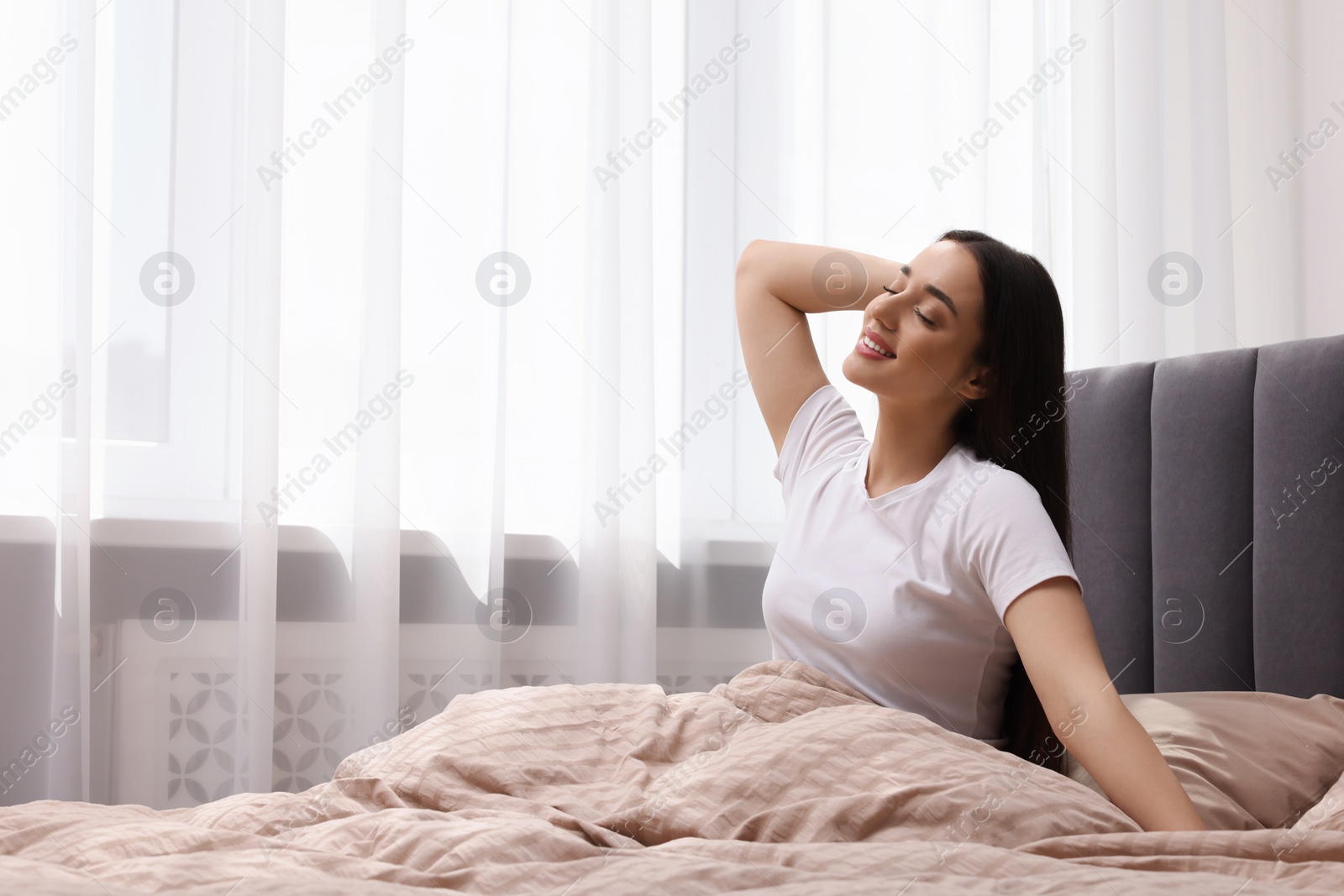 Photo of Beautiful woman in bed at home, space for text. Lazy morning