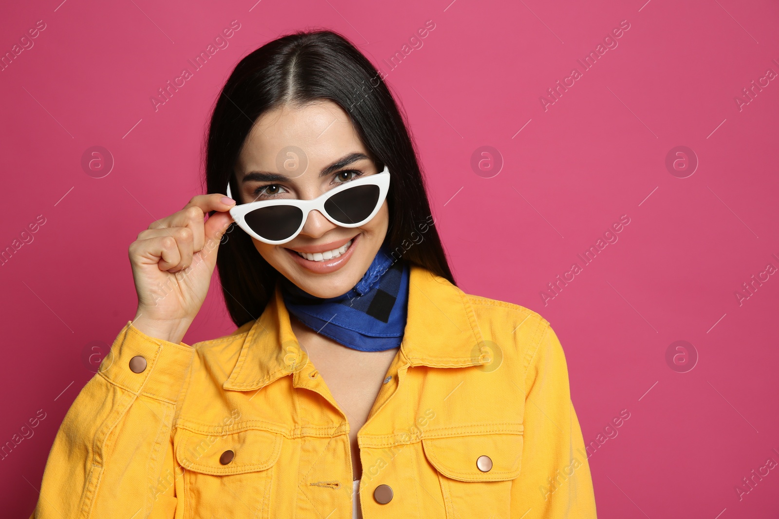 Photo of Fashionable young woman in stylish outfit with bandana on pink background, space for text