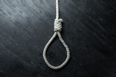 Rope noose on black table, top view